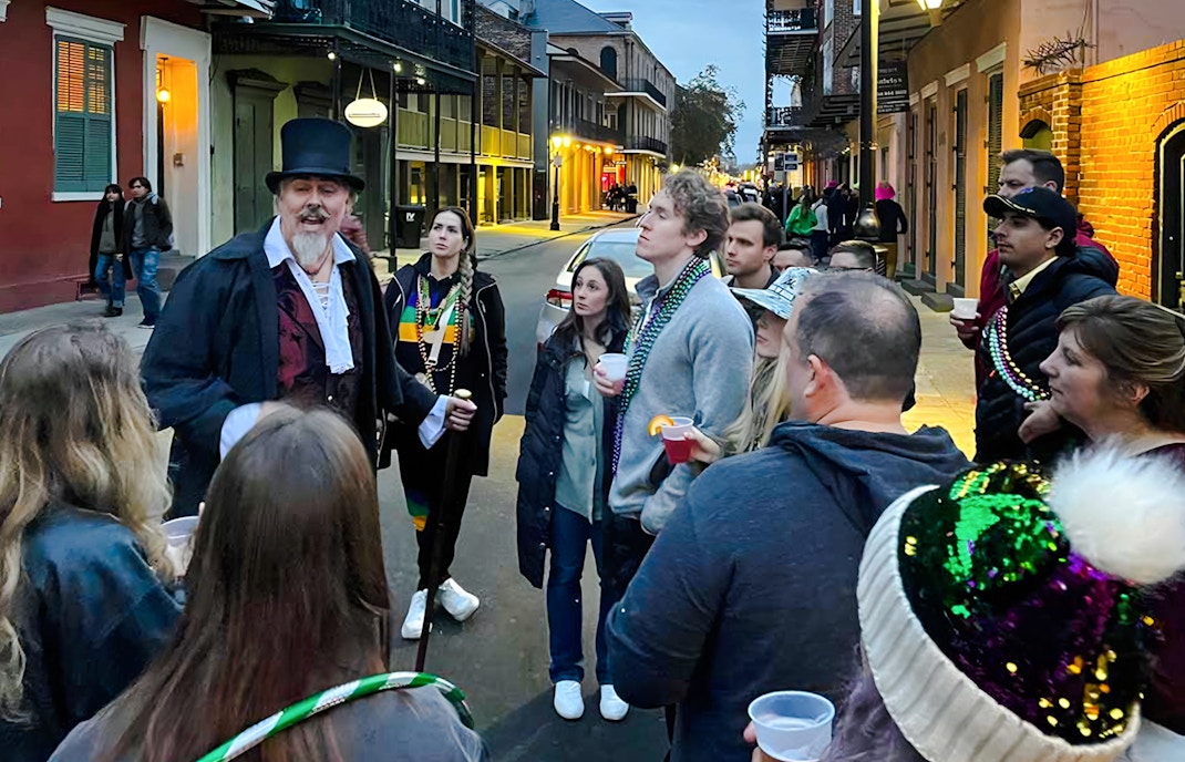 Group listening to a guide during New Orleans Haunted Ghost, Voodoo & Vampire Tour.