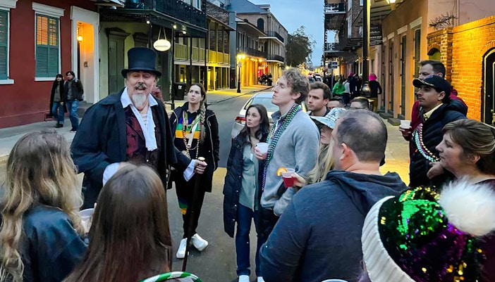 Group listening to a guide during New Orleans Haunted Ghost, Voodoo & Vampire Tour.