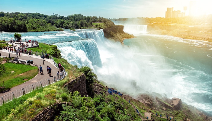 Niagara Falls State Park view with cascading waterfalls and surrounding lush greenery.