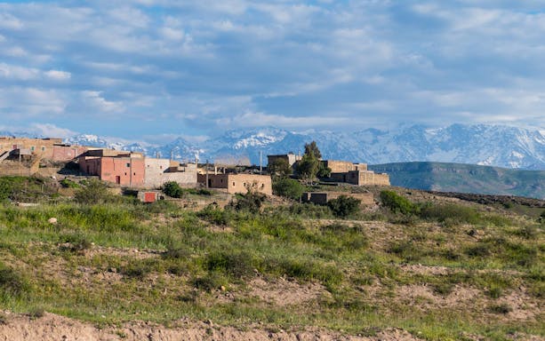 Essaouira village with Atlas Mountains in the background on a full day tour.