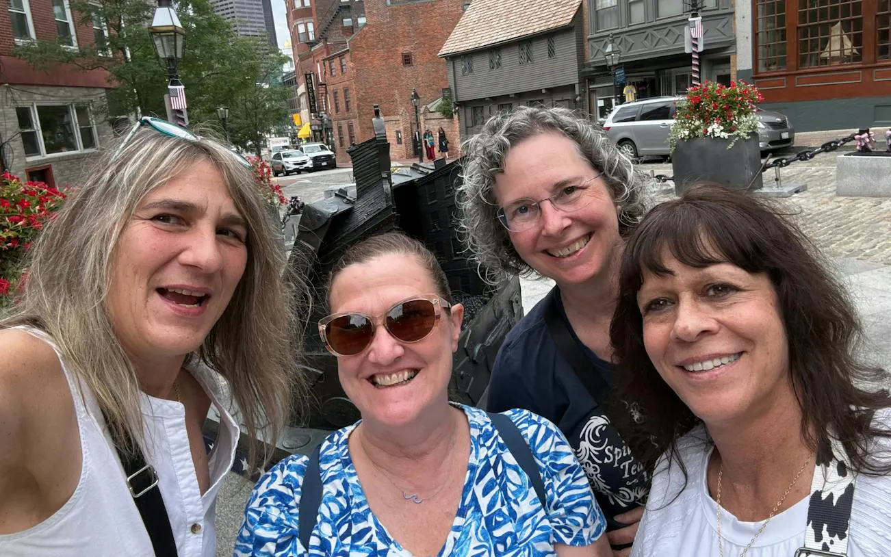 Group of people exploring historic Boston street during self-guided city game.