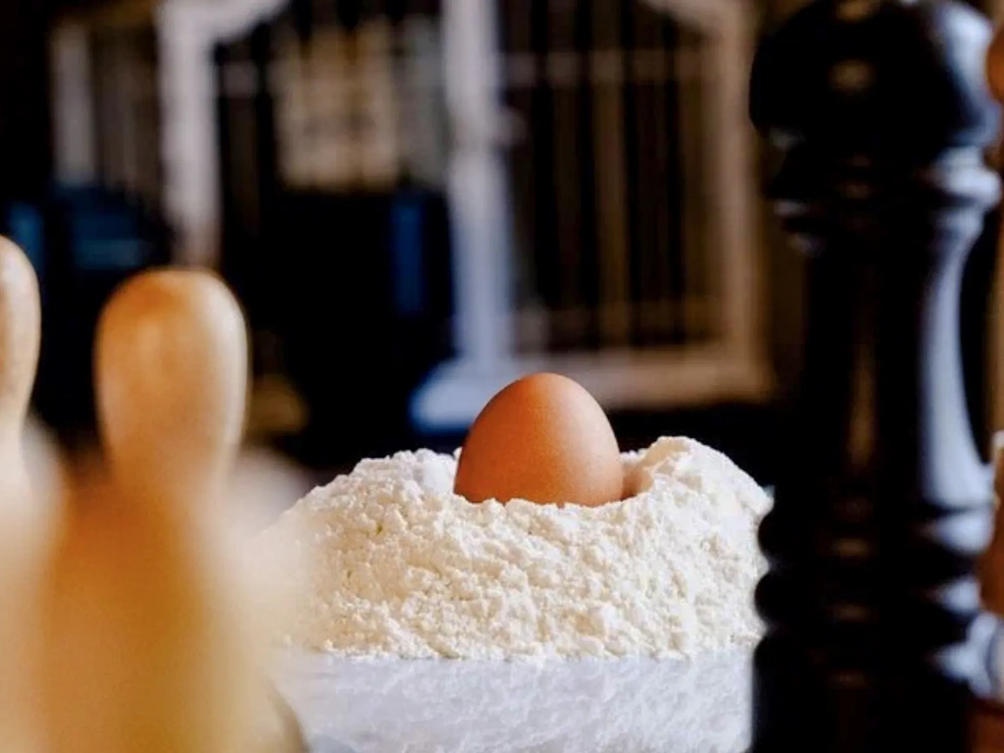 Egg nestled in flour for pasta making in Florence cooking class.