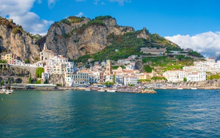 Amalfi Coast view with colorful buildings and cliffs from a boat tour.