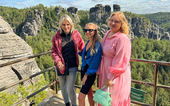 Visitors enjoying the view from Bastei Bridge in Saxon Switzerland National Park.