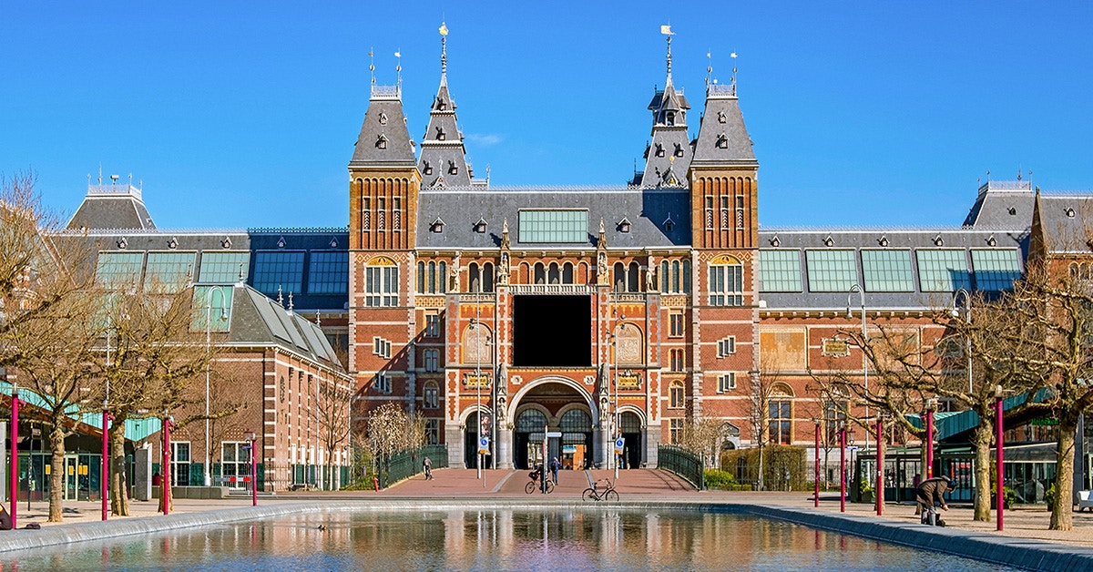 Rijksmuseum facade with reflection in Amsterdam, Netherlands.