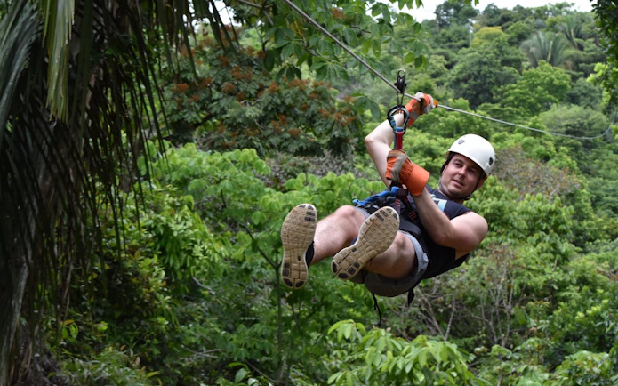 Ziplining through lush rainforest canopy near Manuel Antonio.