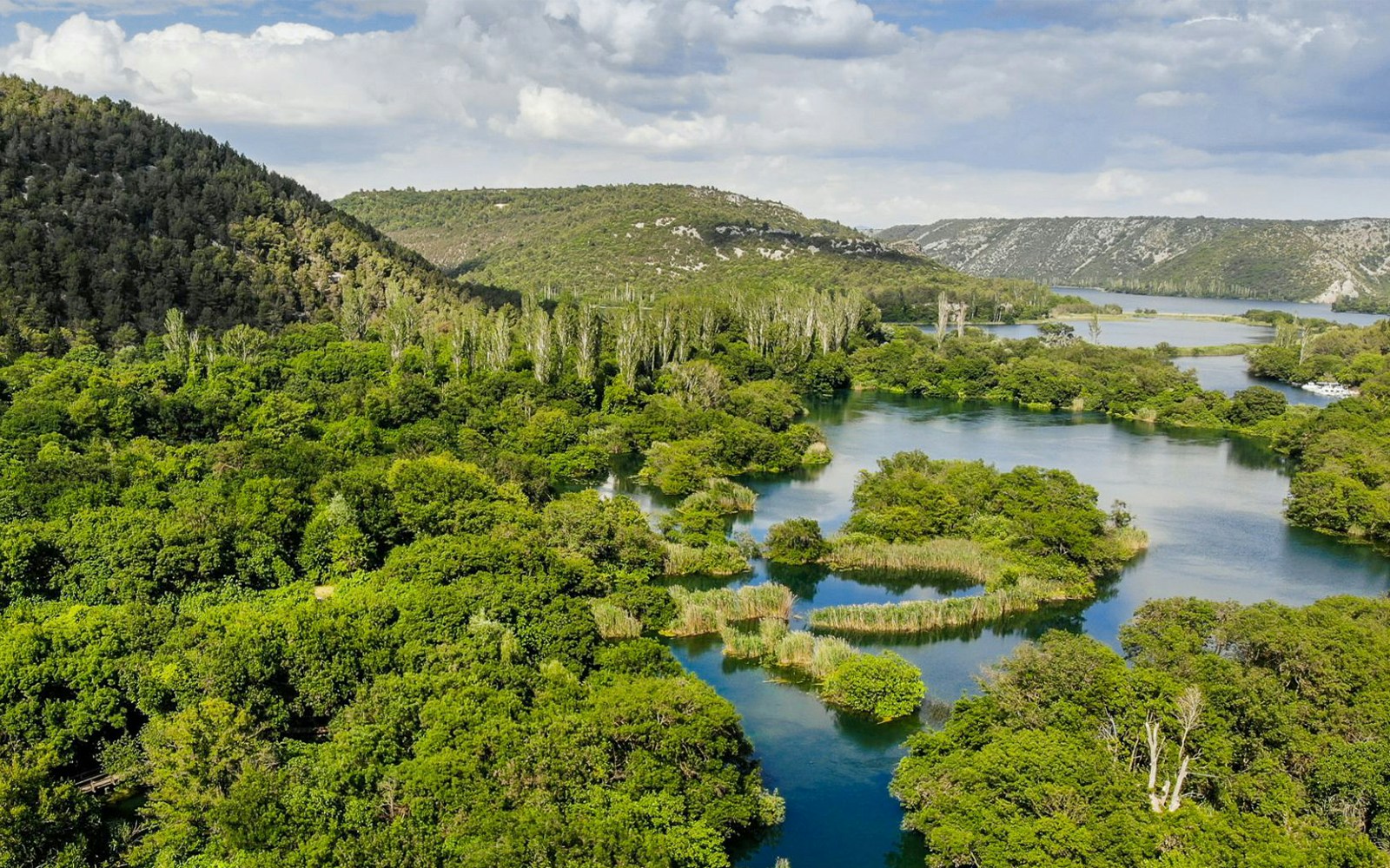 Aerial view of Krka River winding through lush greenery in Croatia.