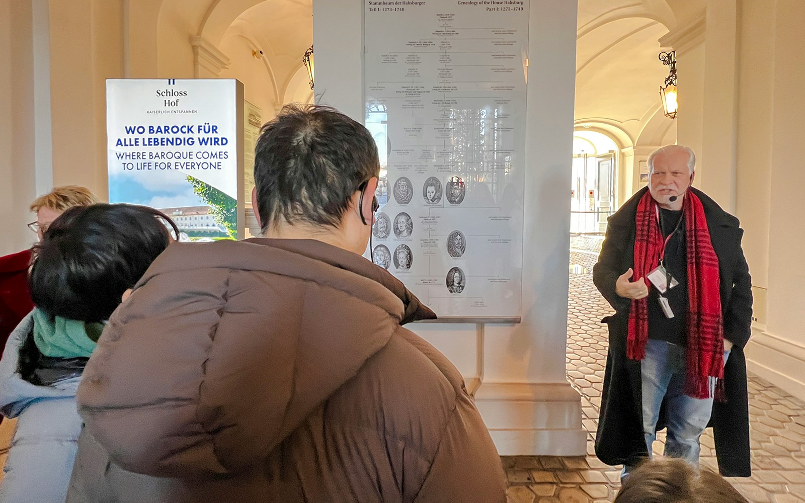 Guide explaining Habsburg genealogy during Schönbrunn Palace tour, Vienna.