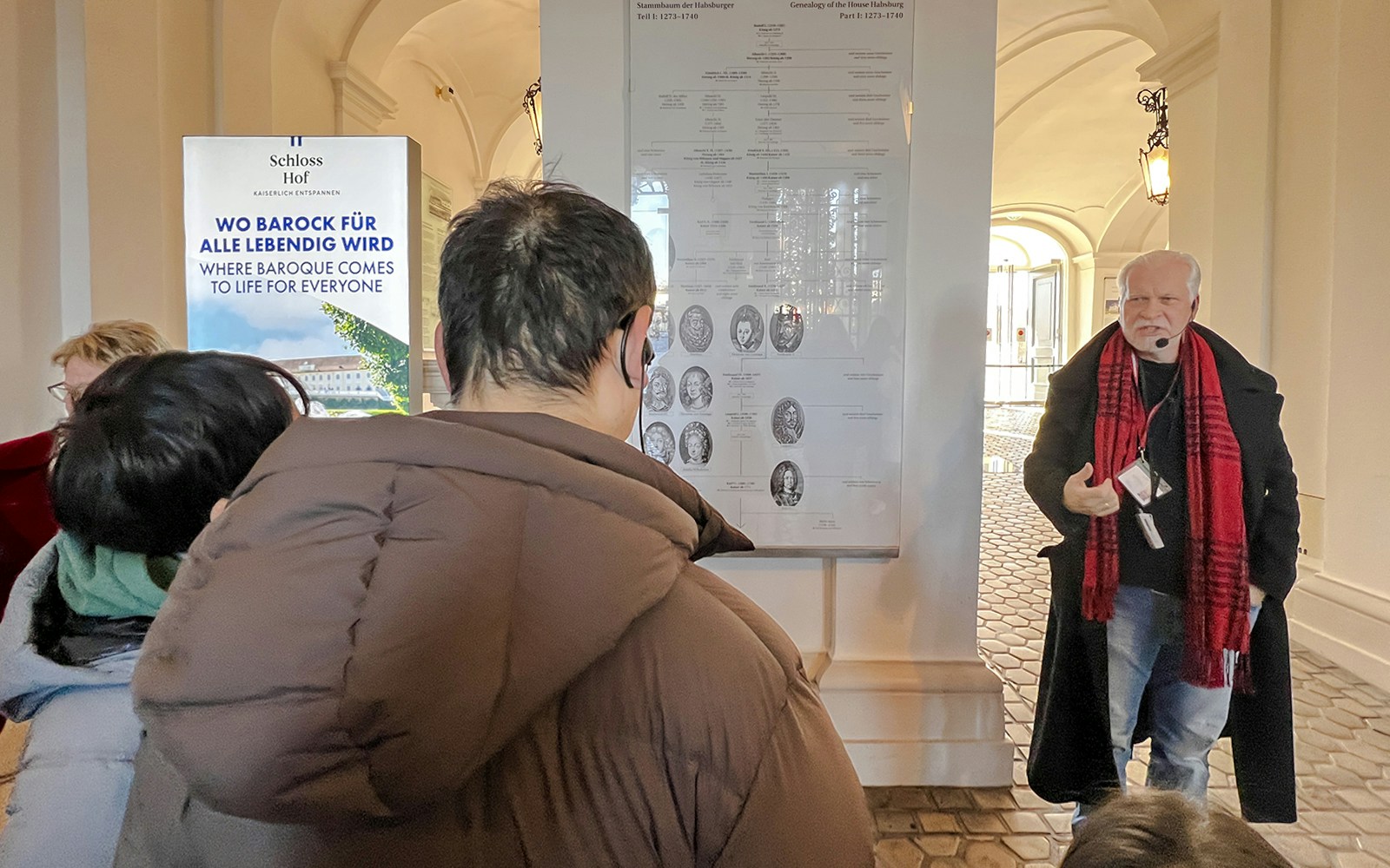 Guide explaining Habsburg genealogy during Schönbrunn Palace tour, Vienna.