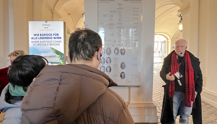 Guide explaining Habsburg genealogy during Schönbrunn Palace tour, Vienna.