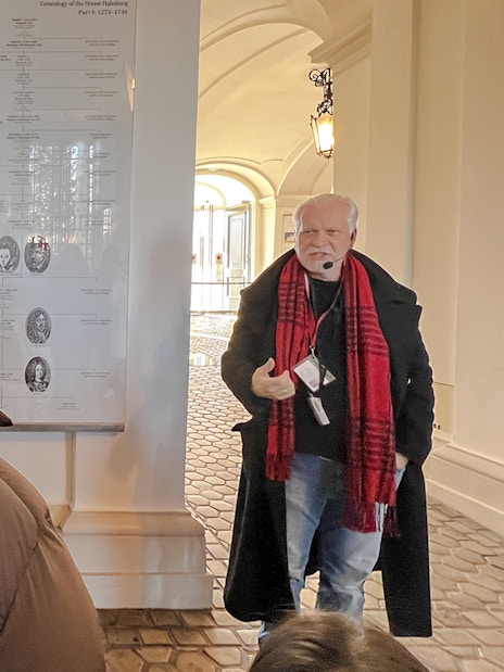 Guide explaining Habsburg genealogy during Schönbrunn Palace tour, Vienna.