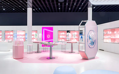 Swarovski Crystal Worlds exhibition room with pink displays and crystal exhibits.