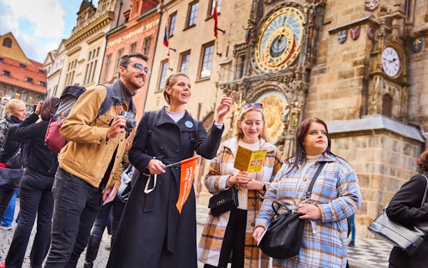 Tourists exploring Prague Astronomical Clock with guide, using 48/72/120 Hours Prague Visitor Pass.