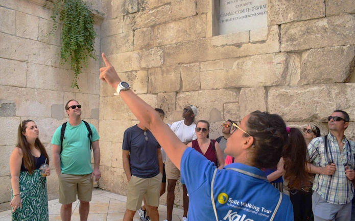 Tour guide leading a group at Diocletian's Palace in Split's Old Town.
