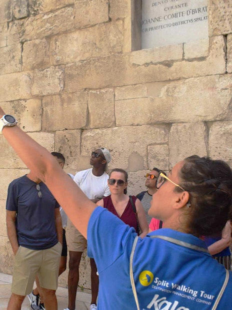 Tour guide leading a group at Diocletian's Palace in Split's Old Town.