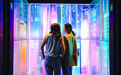 Visitors enjoying digital art installation at Edge NYC Observation Deck.