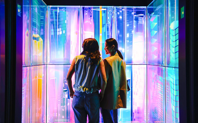 Visitors enjoying digital art installation at Edge NYC Observation Deck.