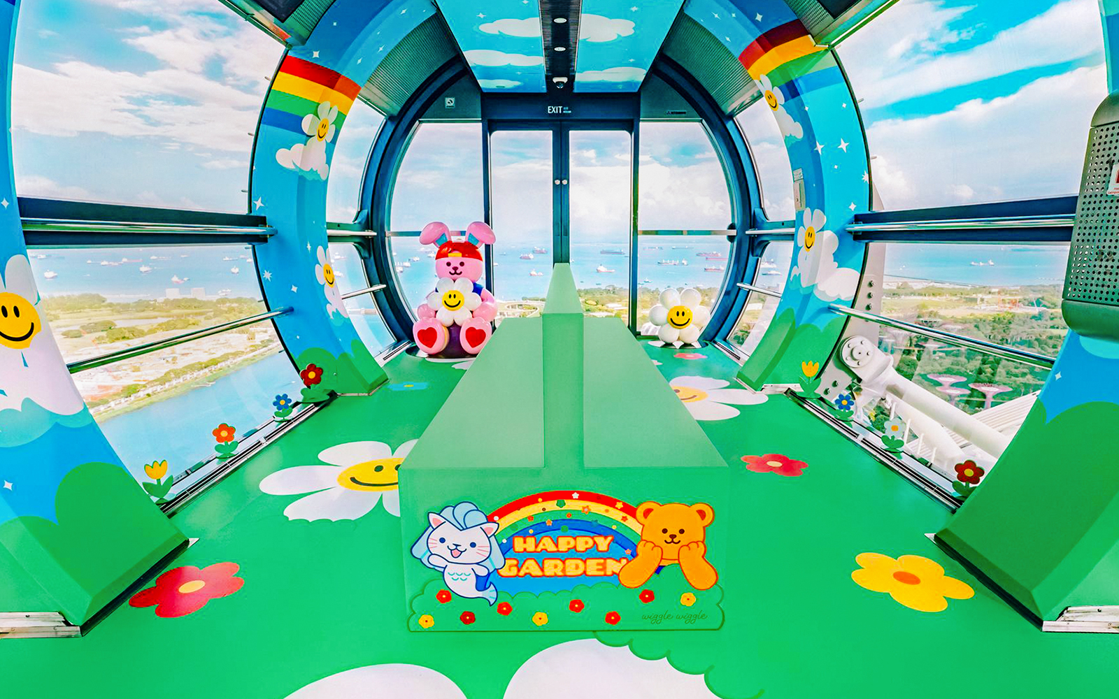 Singapore Flyer capsule interior with colorful cartoon decor and city view.