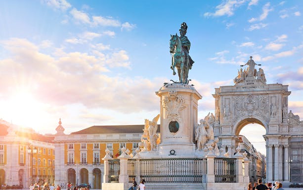 Statue at Praca do Comercio with Triumphal Arch in Lisbon, Portugal.