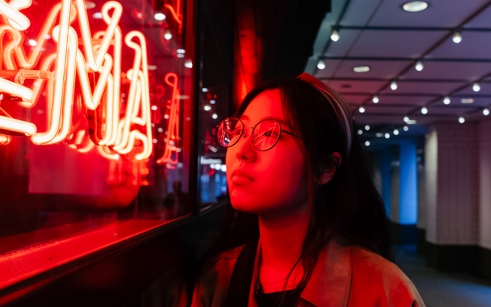 Person admiring neon lights at God's Own Junkyard, London.