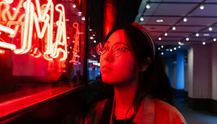 Person admiring neon lights at God's Own Junkyard, London.