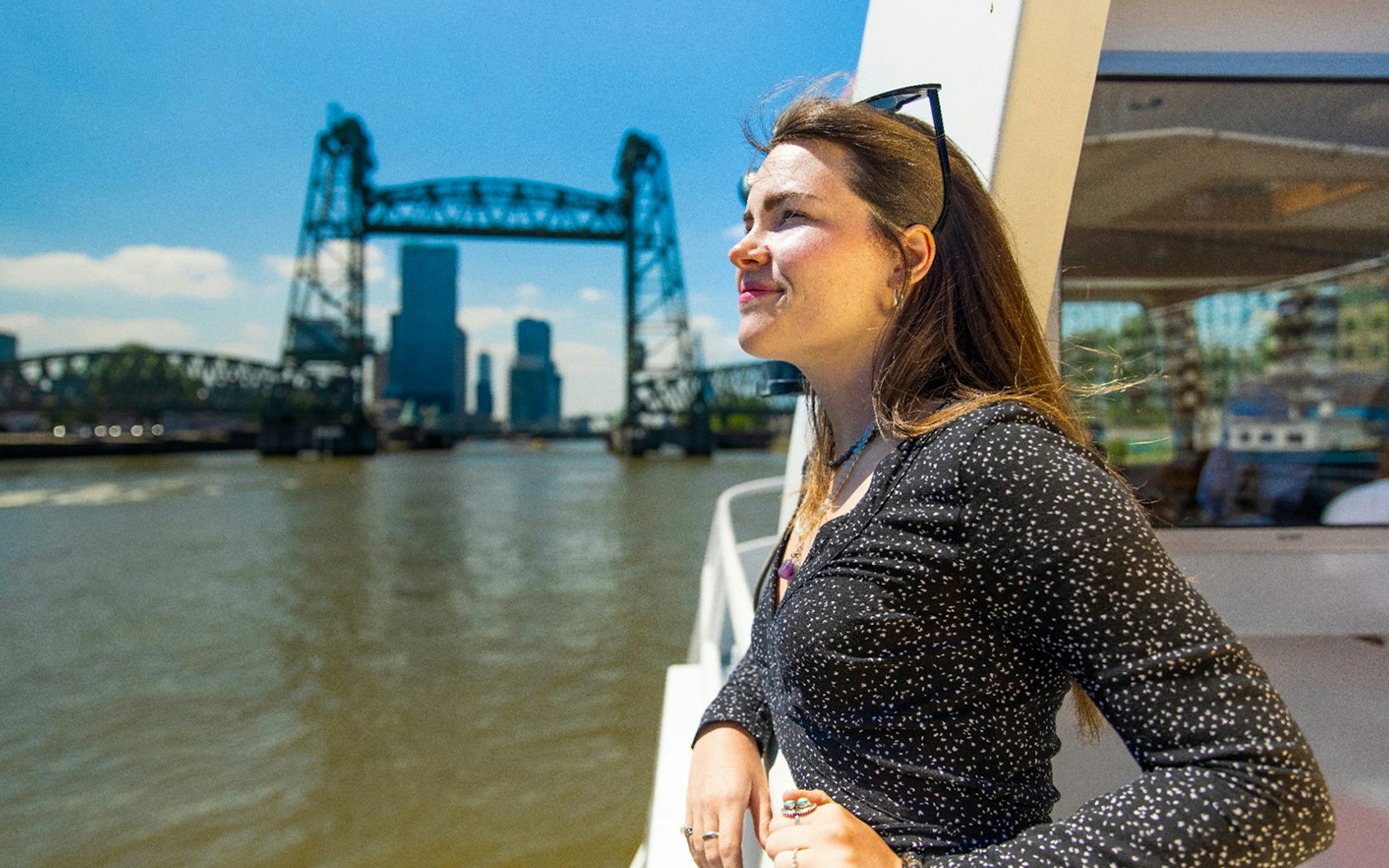 River cruise guest enjoying Rotterdam skyline views.