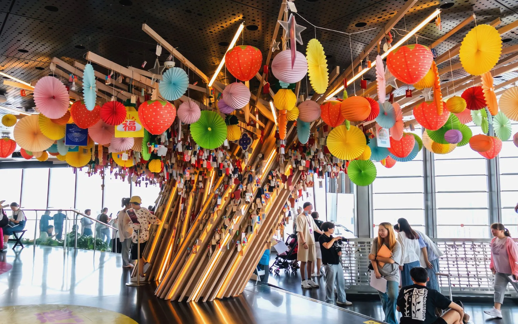 Decorated wishing tree with colorful lanterns on the 118th-floor observation deck of Shanghai Tower.