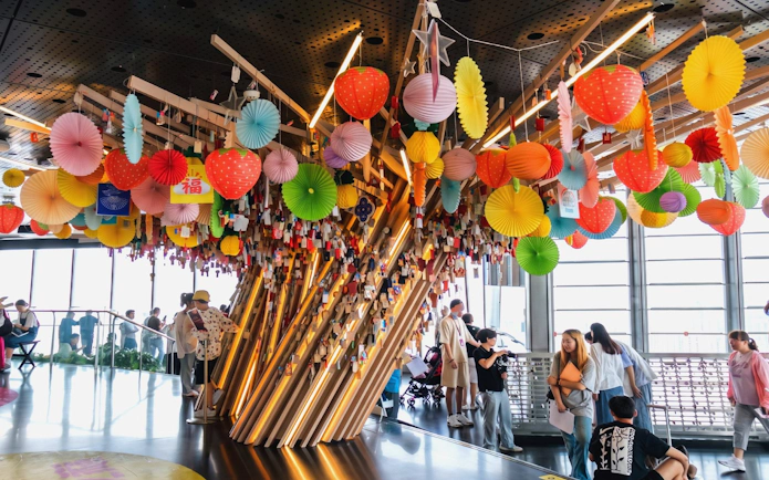 Decorated wishing tree with colorful lanterns on the 118th-floor observation deck of Shanghai Tower.