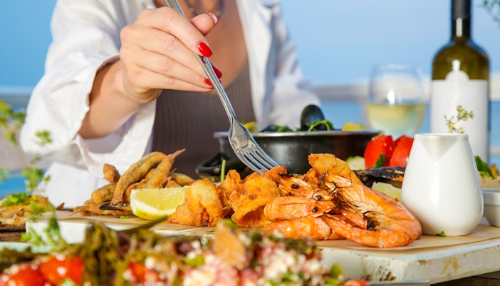 Fresh seafood platter on a beachside table in a coastal town.