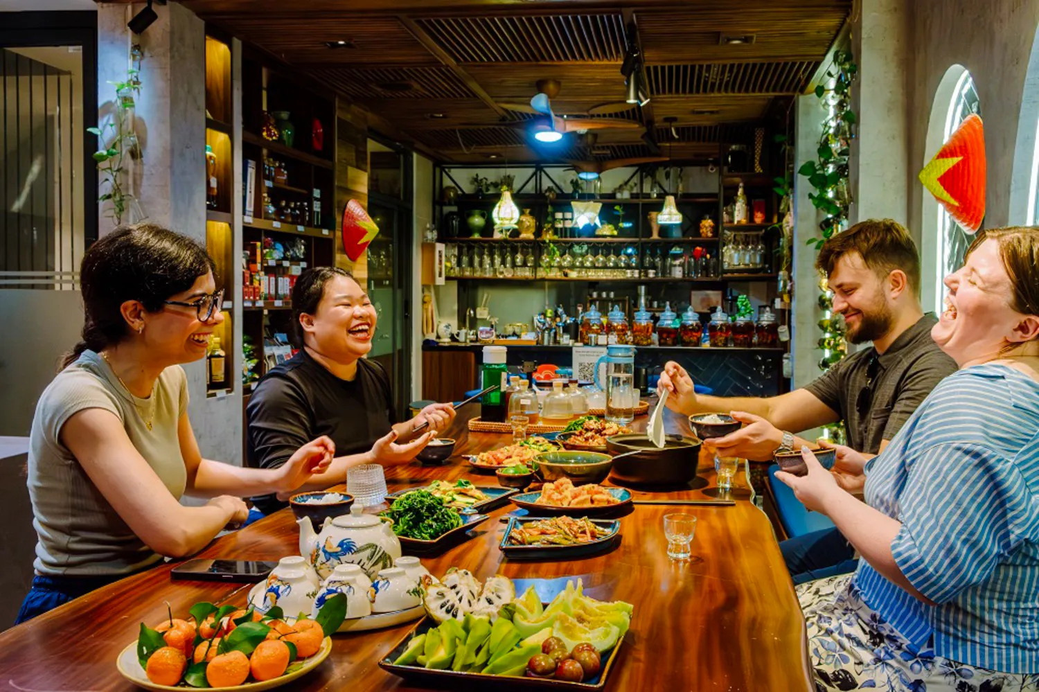 Guests enjoying a traditional meal at a private home dining experience in Hanoi.
