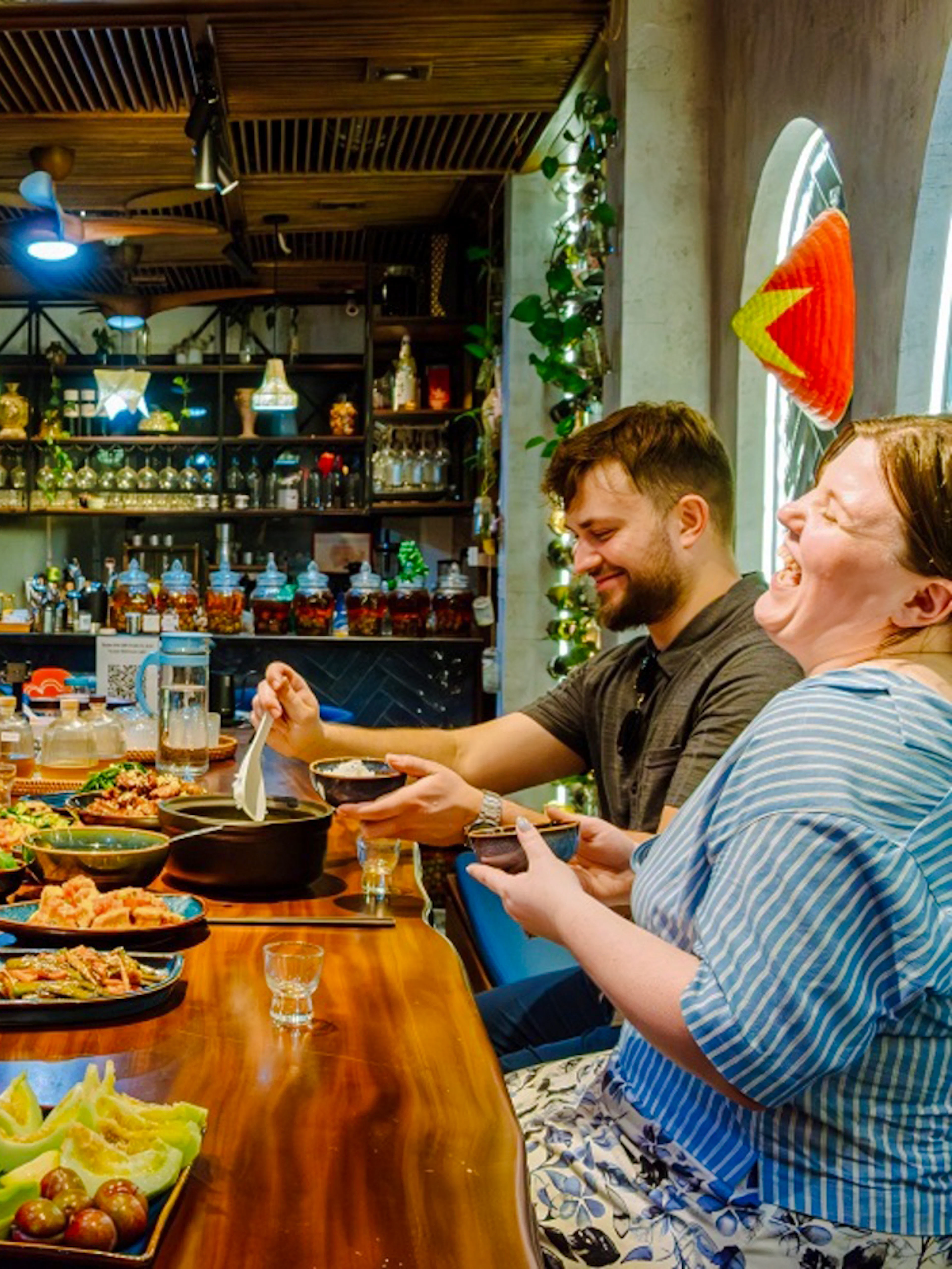 Guests enjoying a traditional meal at a private home dining experience in Hanoi.
