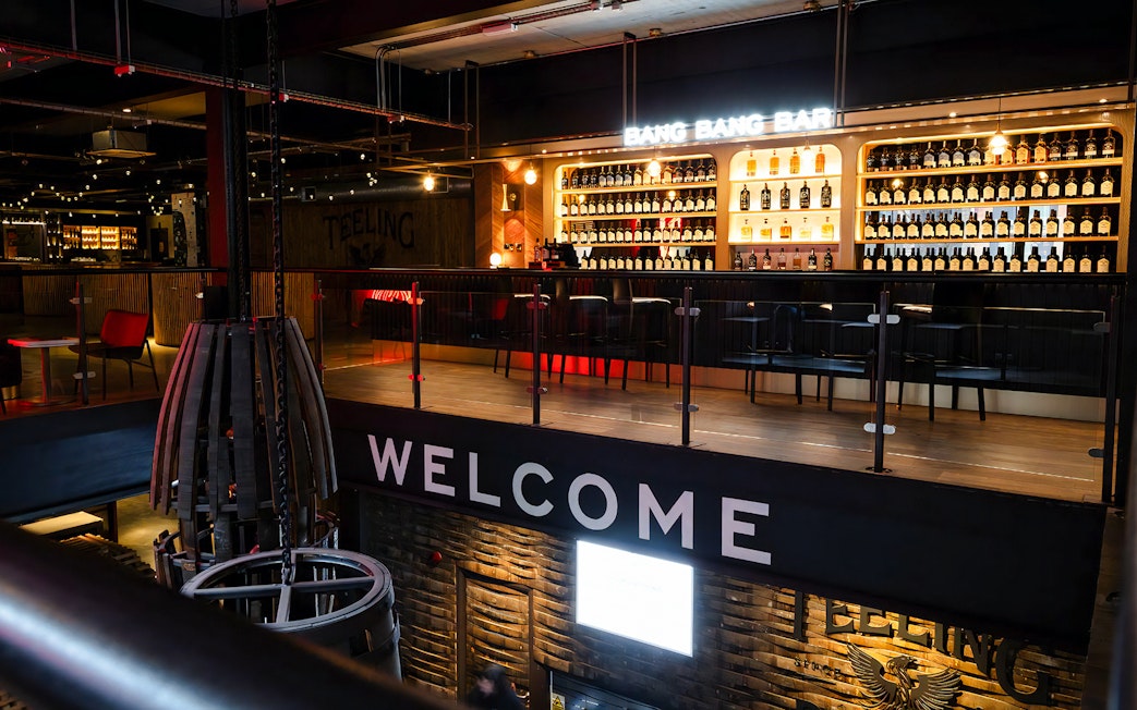 Bar area at Teeling Distillery with bottles displayed on shelves, Dublin, Ireland.