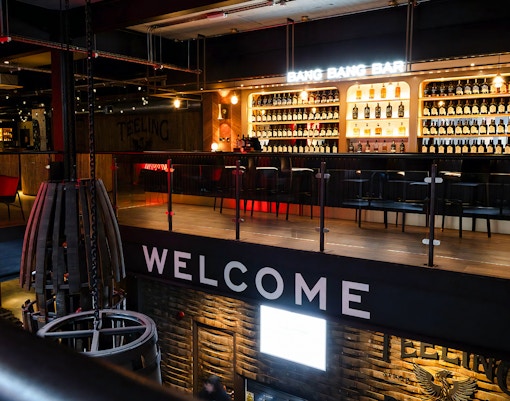 Bar area at Teeling Distillery with bottles displayed on shelves, Dublin, Ireland.