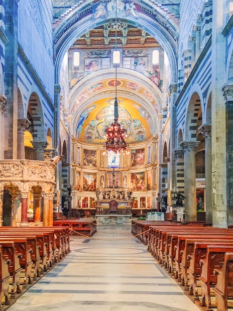 Interior of Pisa Cathedral with ornate columns and detailed frescoes, part of the Florence and Pisa tour.