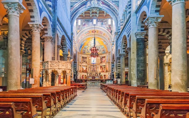 Interior of Pisa Cathedral with ornate columns and detailed frescoes, part of the Florence and Pisa tour.