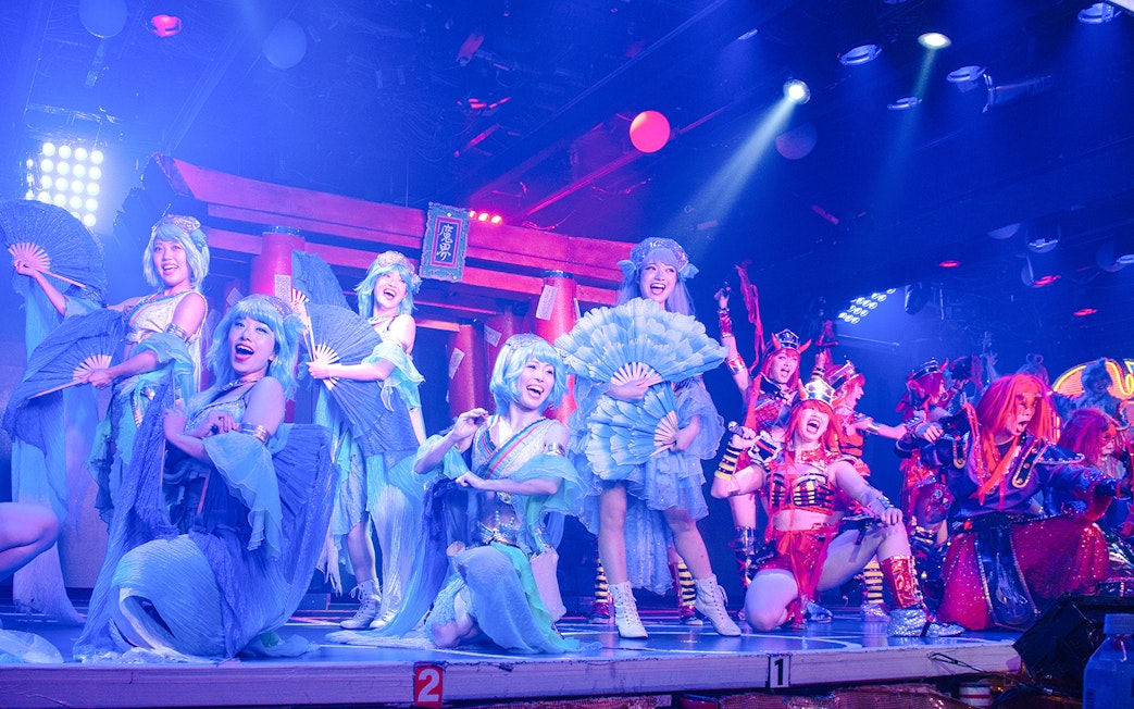 Performers in vibrant costumes on stage at Samurai Restaurant Show.