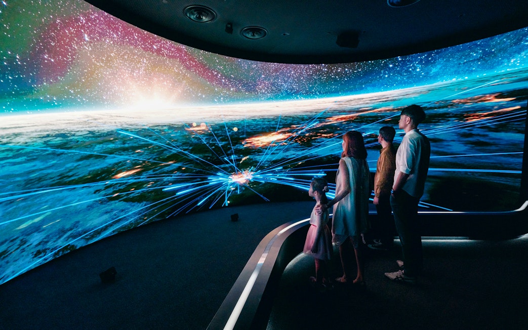 Visitors engaging with digital display at Changi Experience Studio, showcasing interactive experiences.