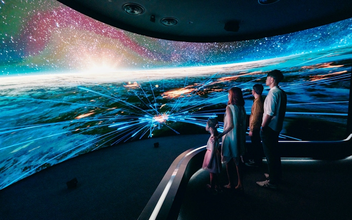 Visitors engaging with digital display at Changi Experience Studio, showcasing interactive experiences.