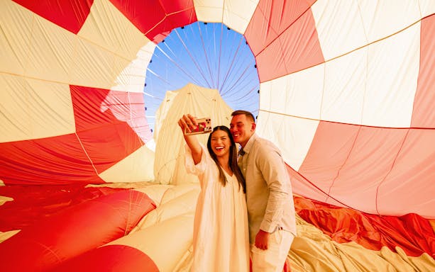 Couple taking a selfie inside a hot air balloon during Gold Coast Classic Ballooning tour.