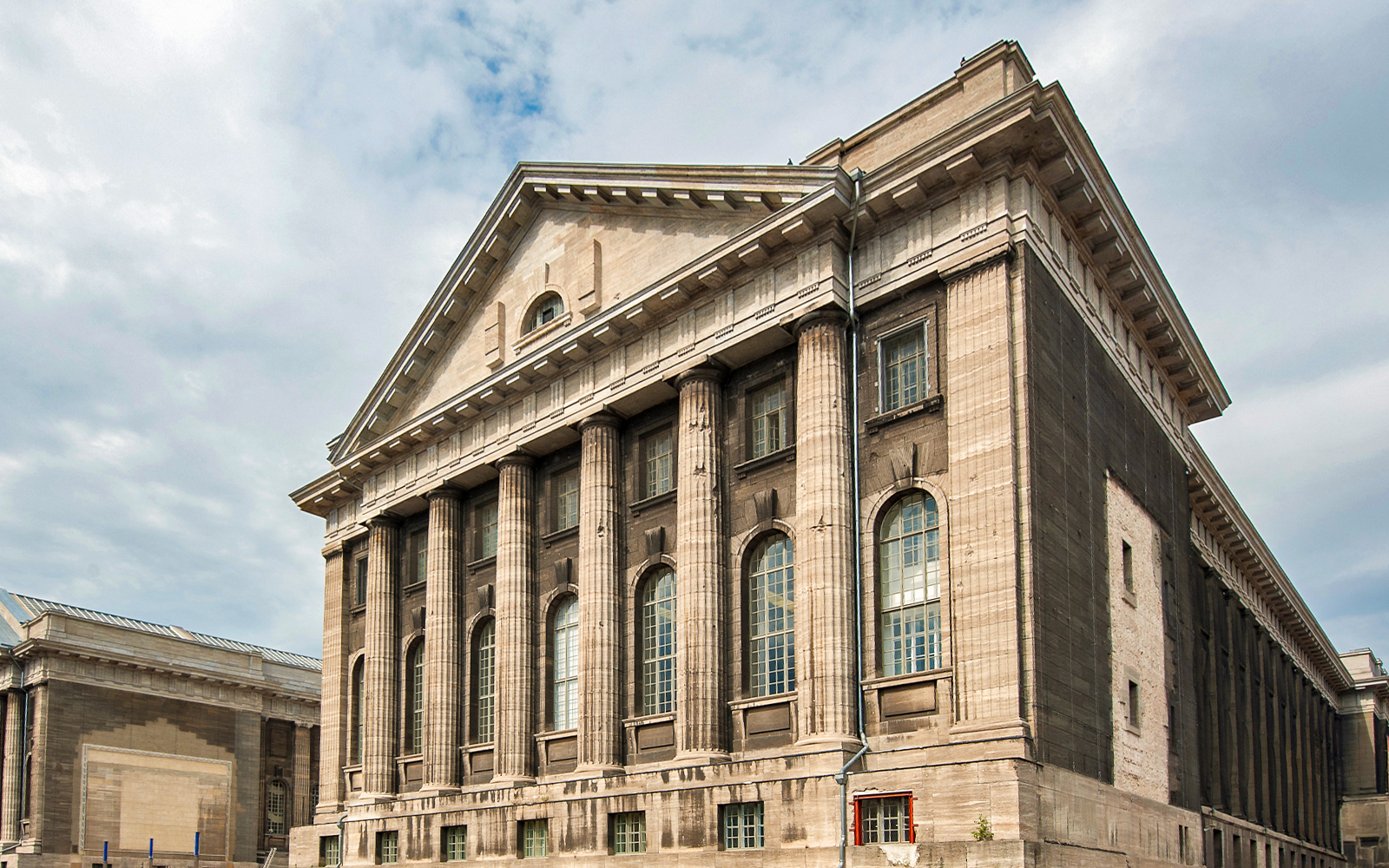 Pergamon Museum Berlin exterior with visitors exploring the historic architecture.