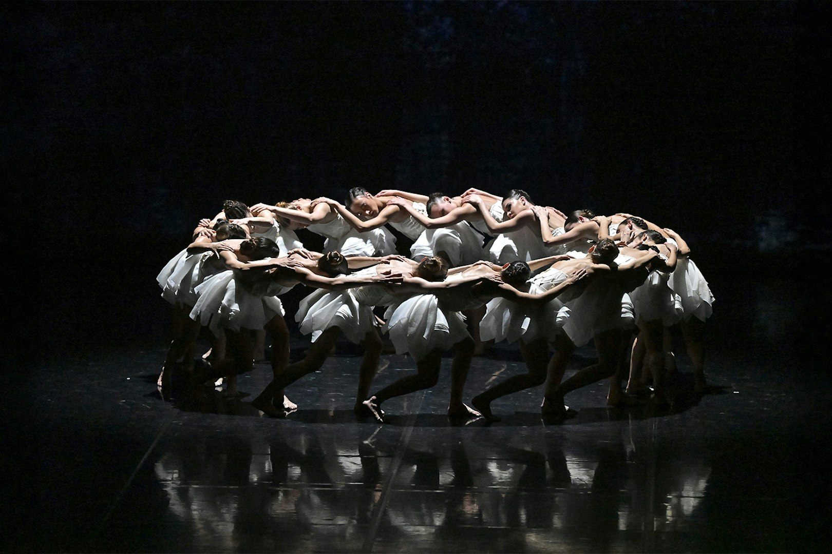 Dancers in a circle formation during Ballet Preljocaj's Swan Lake performance.