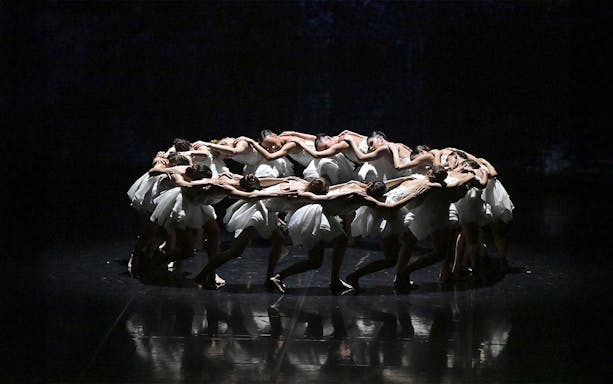 Dancers in a circle formation during Ballet Preljocaj's Swan Lake performance.