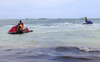 Jet-ski riders on the waves at Diani Beach, Kenya.