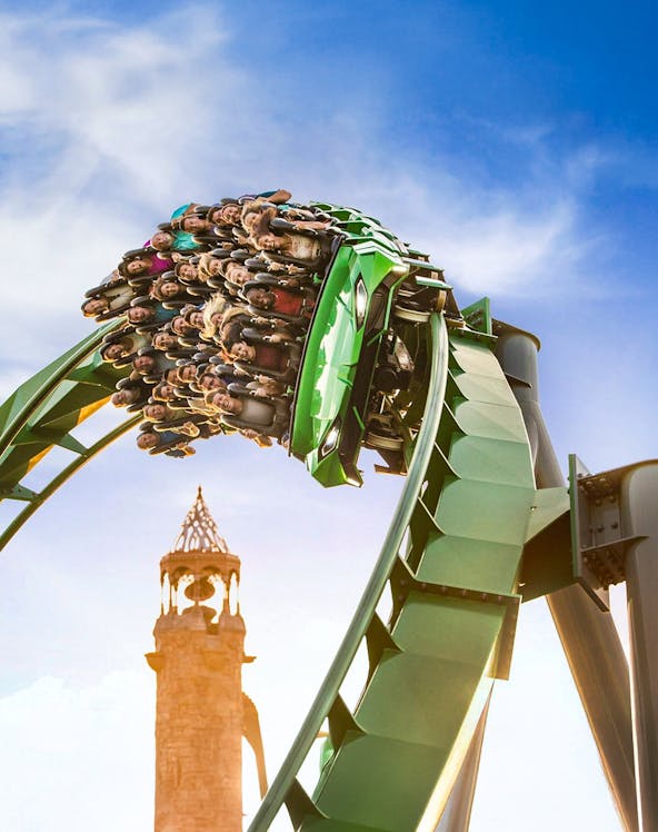 Guests on a rollercoaster with Islands of Adventure tower in background, Universal Studios Orlando.