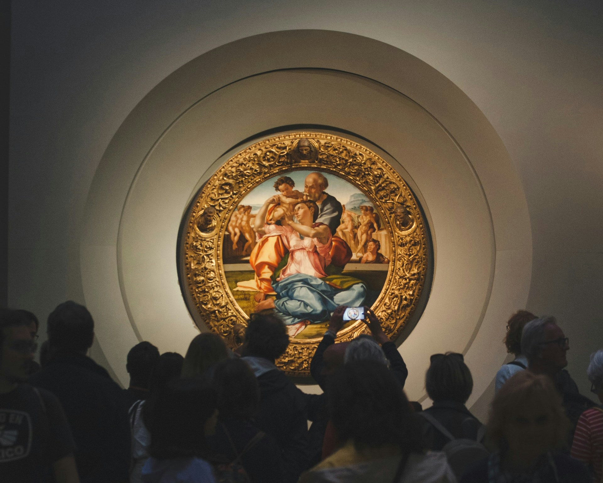 Crowd viewing Michelangelo's Doni Tondo at Uffizi Gallery, Florence.