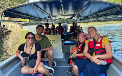 Passengers in life vests on a boat during Langkawi mangrove tour.