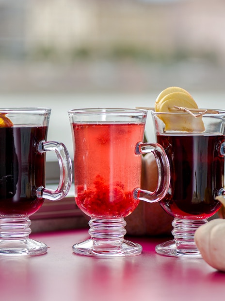 Glasses of mulled wine with spices on a Danube River nighttime sightseeing cruise.