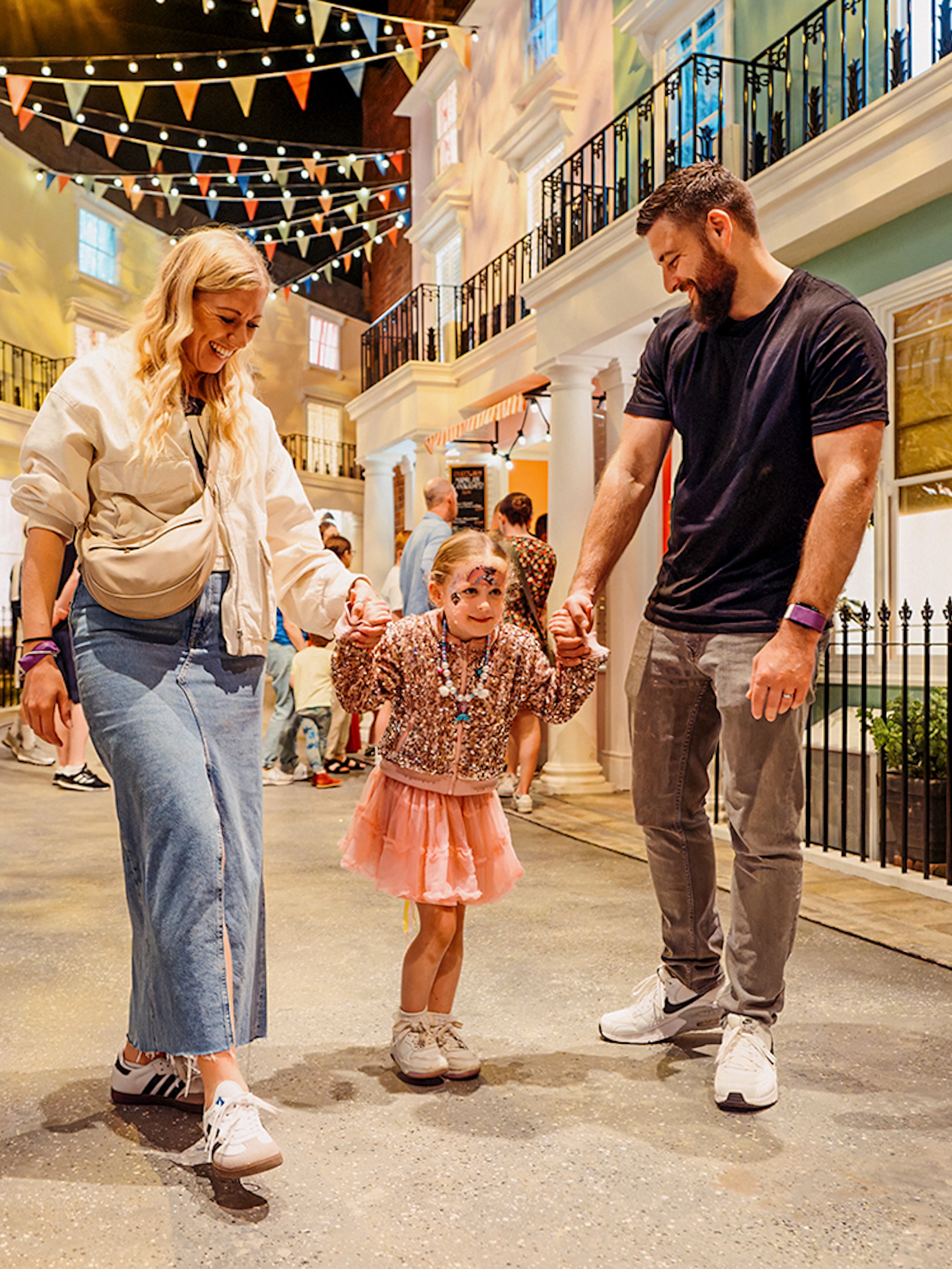 Children with parents enjoying The Paddington Bear Experience in London.