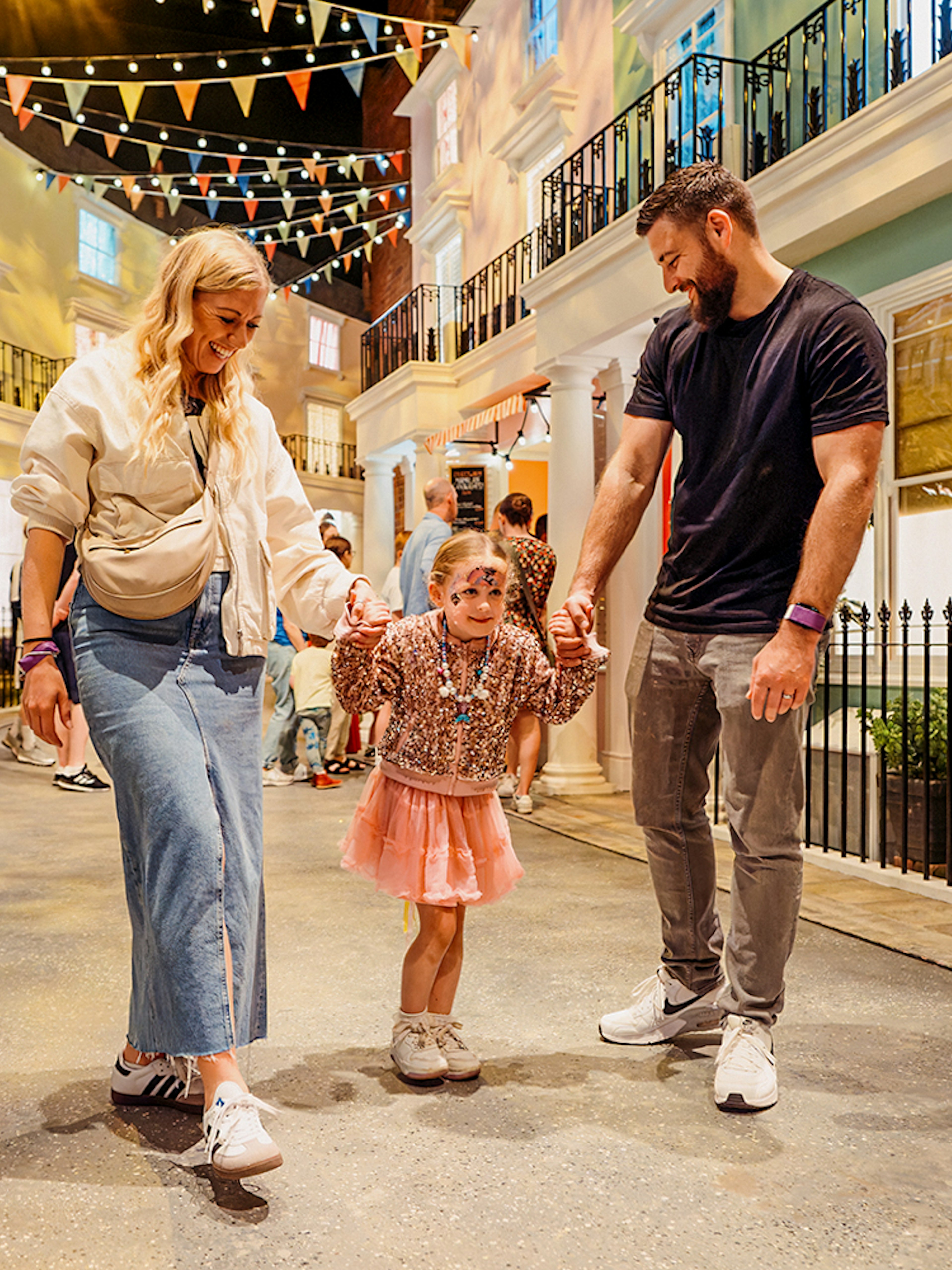 Children with parents enjoying The Paddington Bear Experience in London.