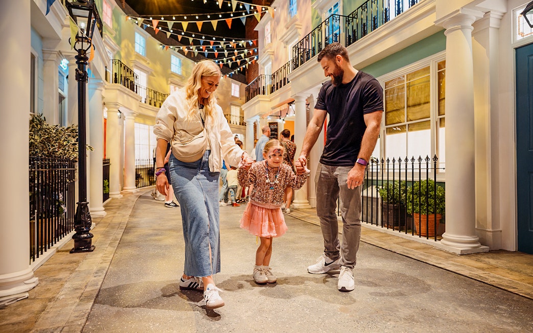 Children with parents enjoying The Paddington Bear Experience in London.